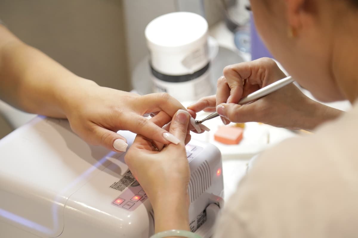 Professional applying builder gel to nails